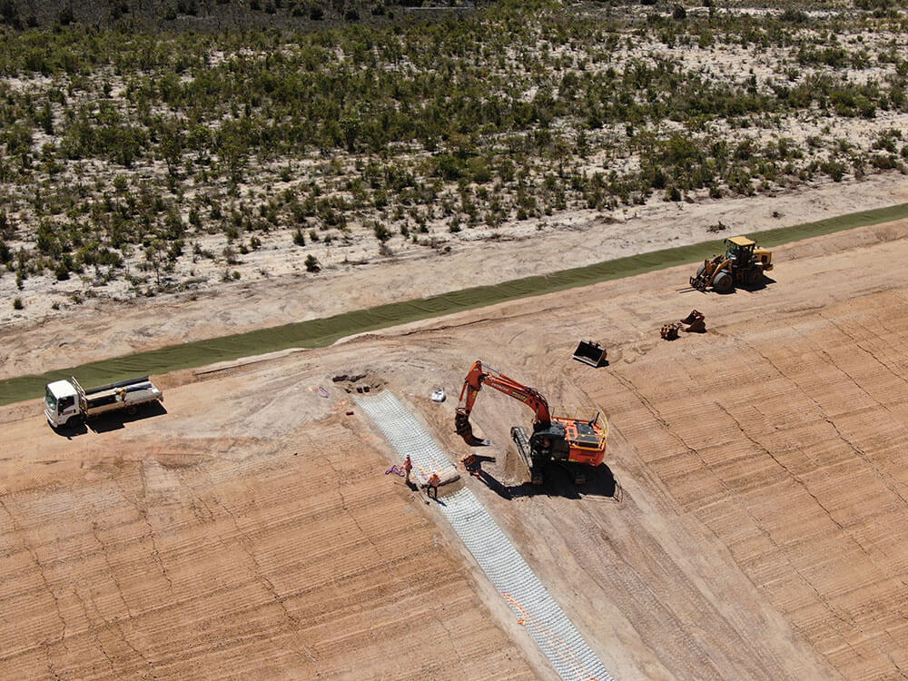 Earthwork machines completing work to establish lateral drains